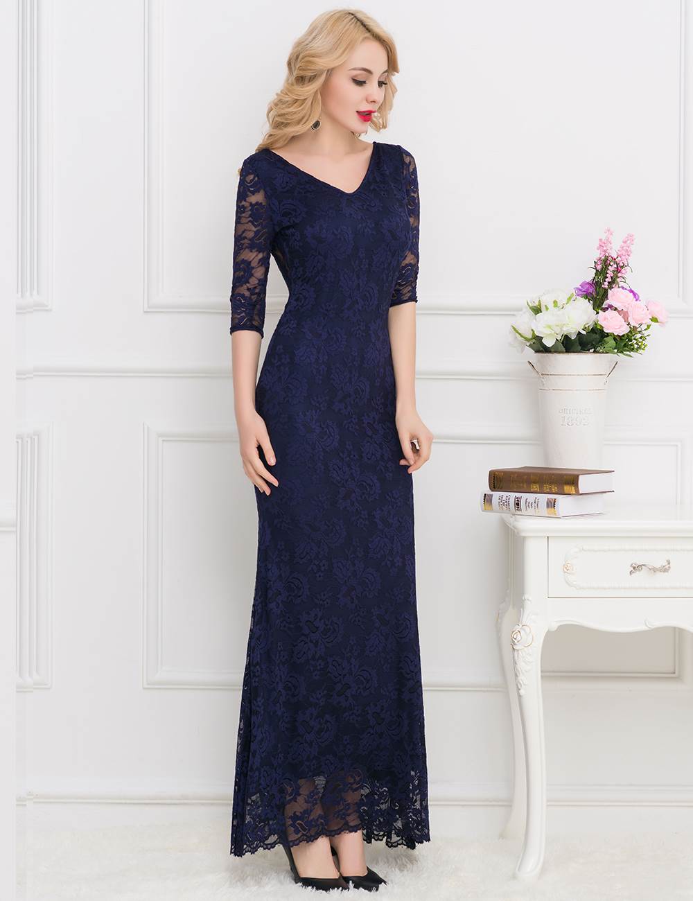 Elegant navy blue lace maxi dress with a stunning open-back design, perfect for evening occasions.